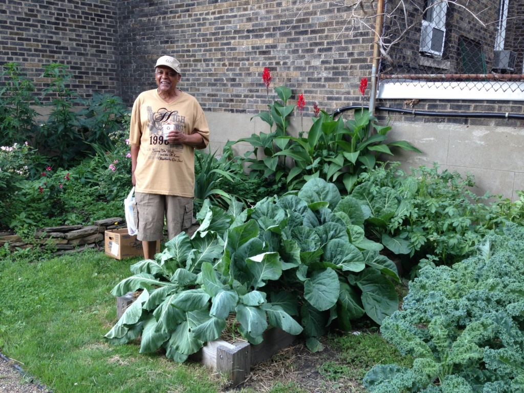 Mr. Galloway stands proud next to the vibrant greens